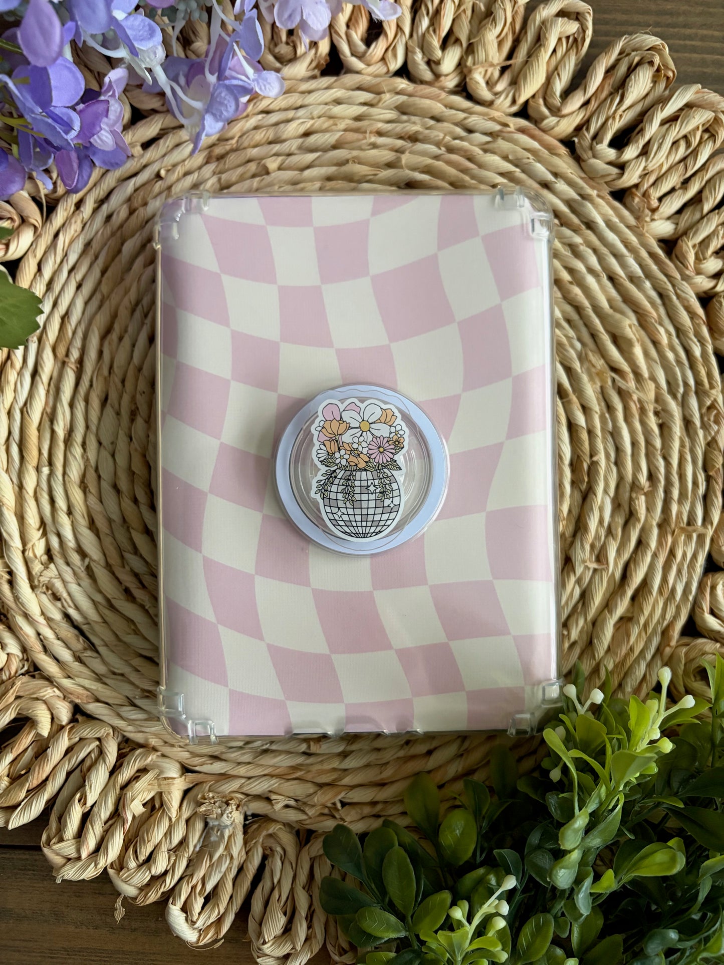 disco planter e reader grip laying on top of pink/ white checkered case