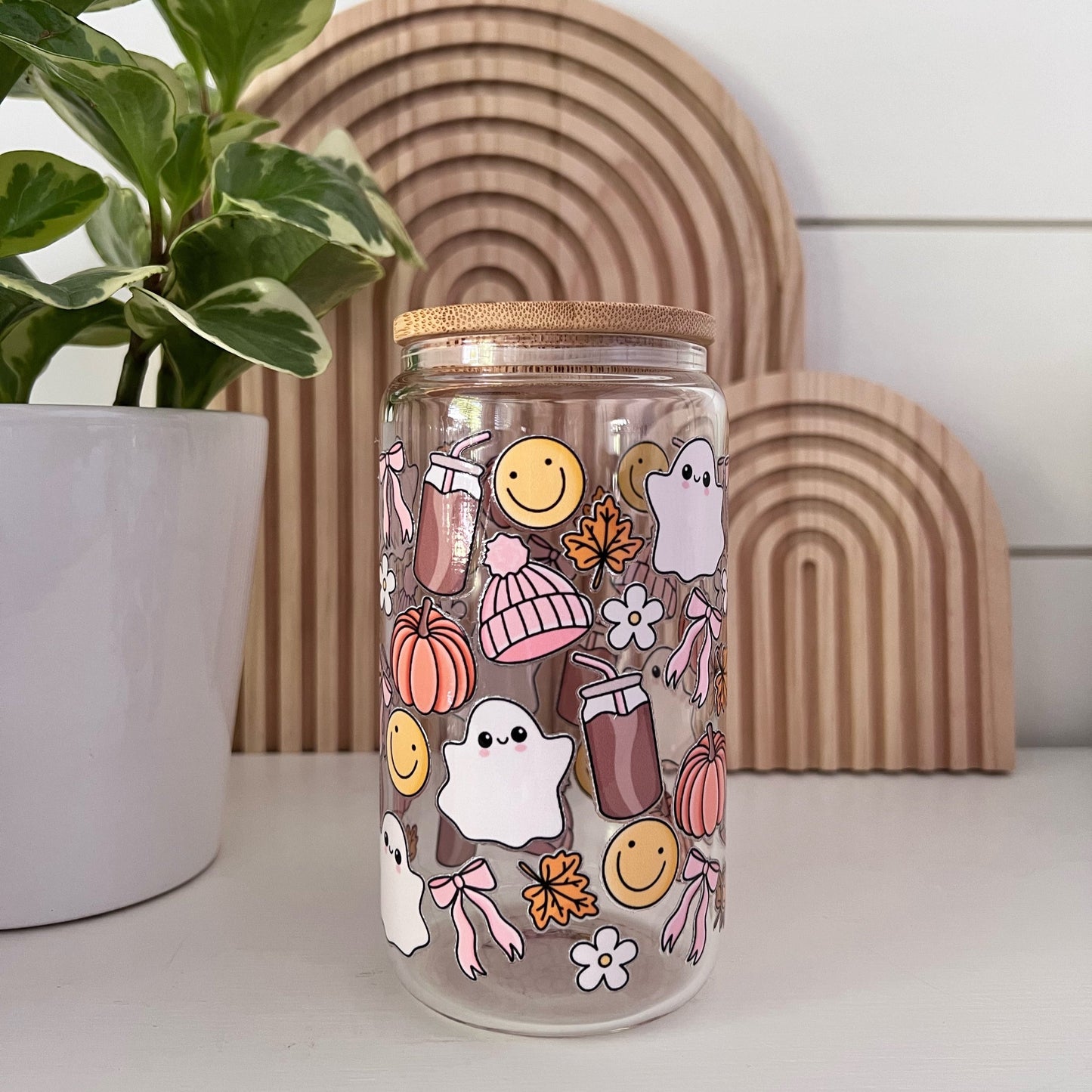 Glass Cup with fall images of ghosts, smiley face, bows, and pumpkins