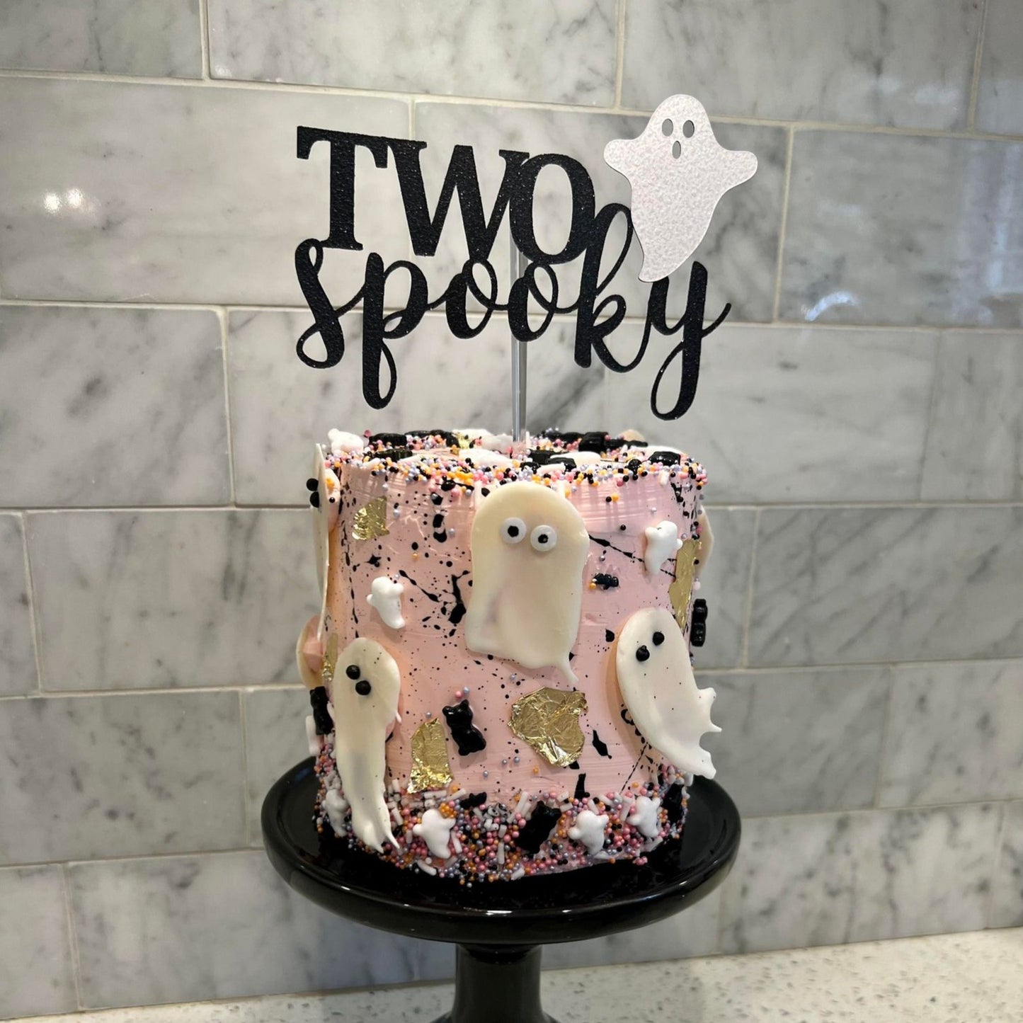 two spooky cake topper on ghost themed cake