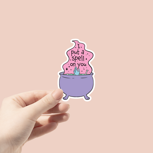i put a spell on you sticker with a purple cauldron and hand coming out with bones