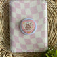 cute phone or e reader grip sitting on top of pink/white checked kindle case