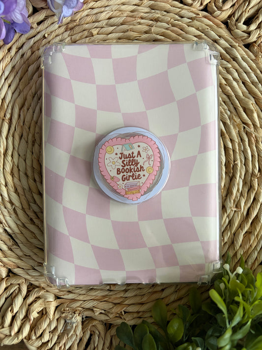 cute phone or e reader grip sitting on top of pink/white checked kindle case