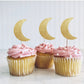 moon shaped cupcake toppers on top of cupcakes
