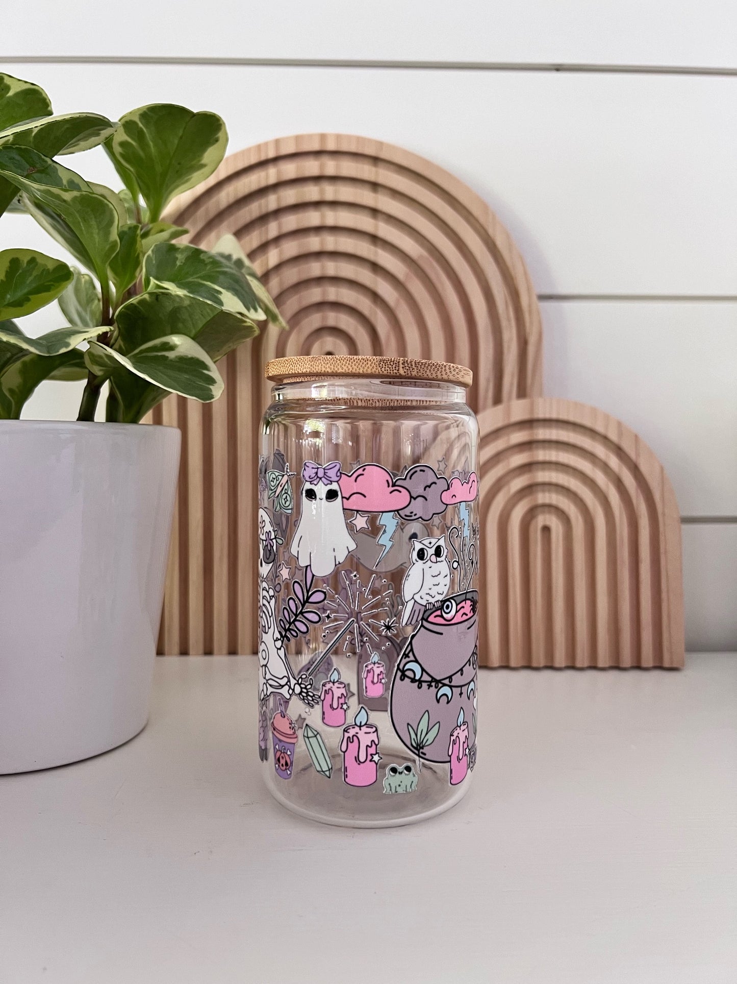 Glass Cup featuring an assortment of pastel colored halloween shapes