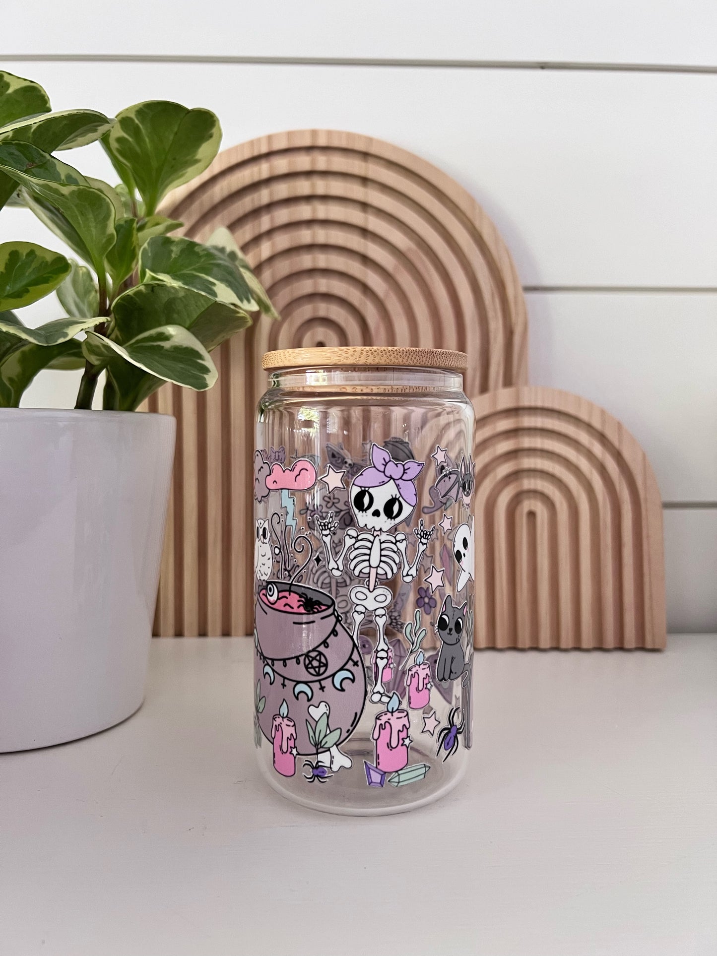 Glass Cup featuring an assortment of pastel colored halloween shapes