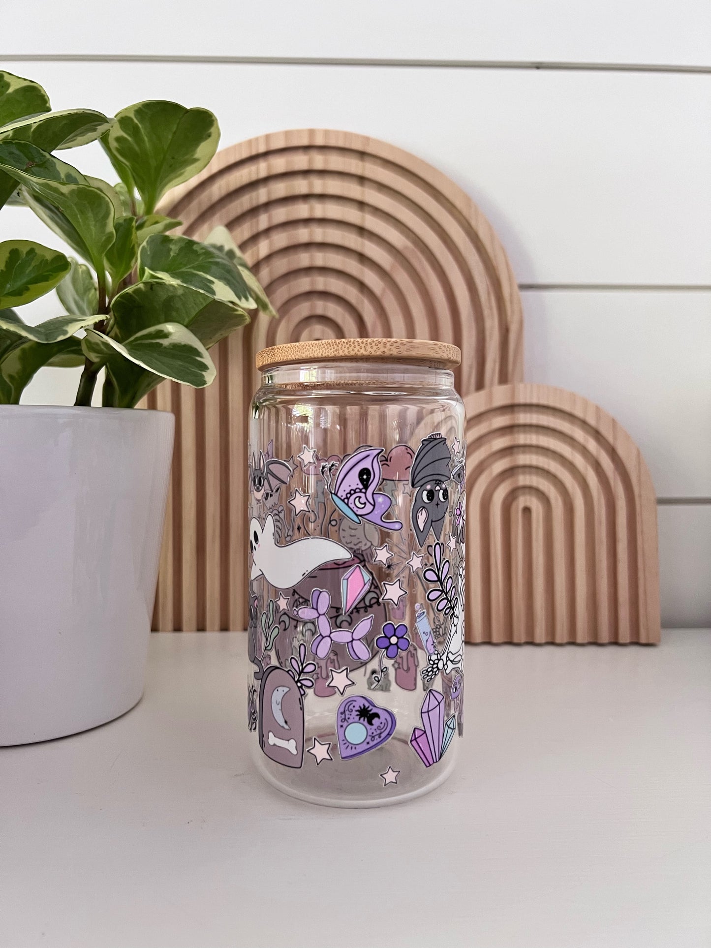 Glass Cup featuring an assortment of pastel colored halloween shapes