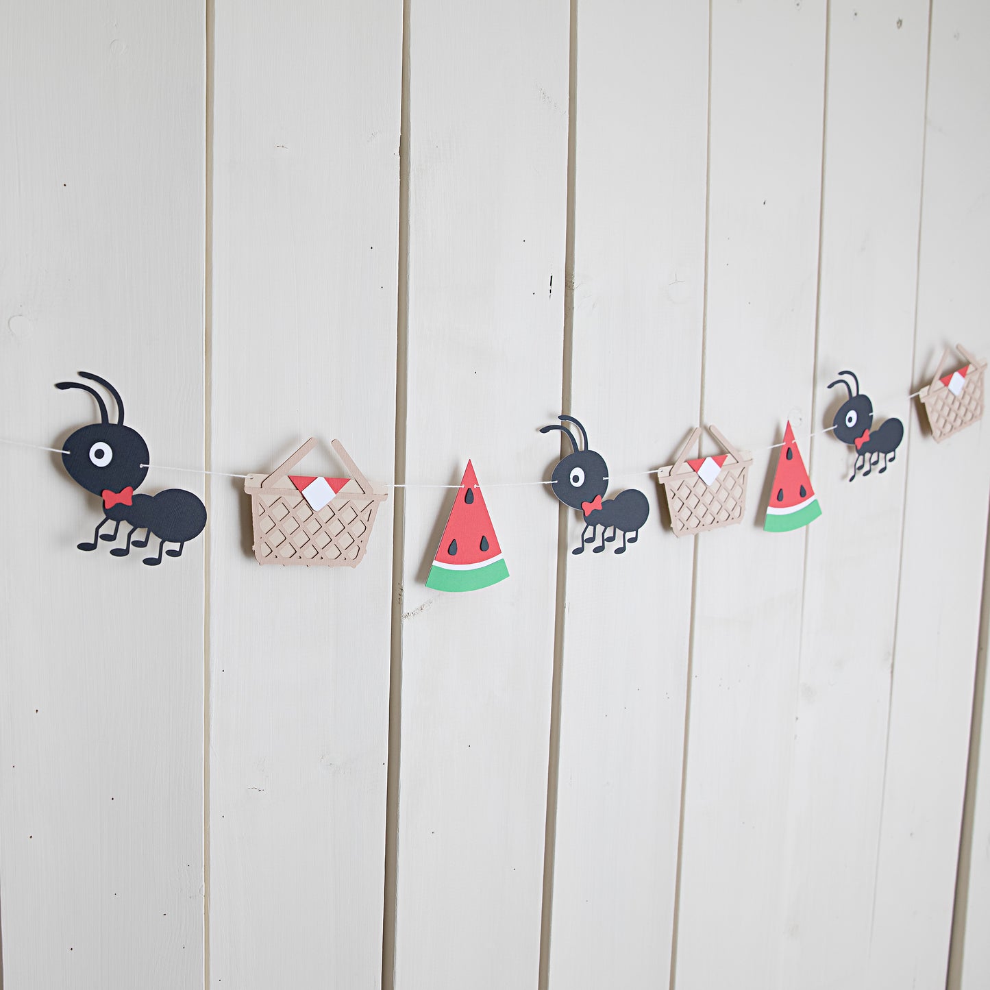 picnic ants themed paper garland strung on the wall
