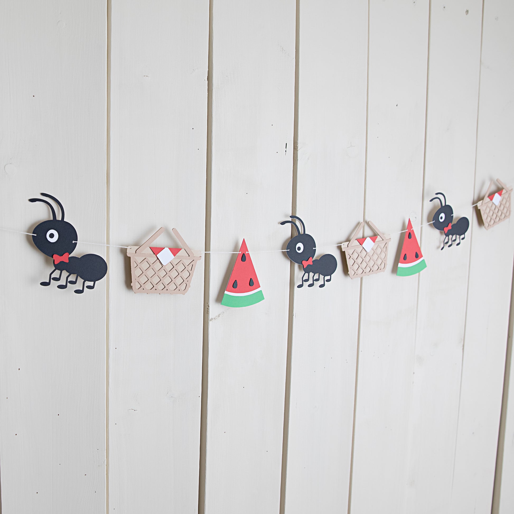picnic ants themed paper garland strung on the wall