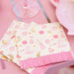 pink hpcus pocus paper napkins with pink fringe and fun halloween shapes sitting on  a table