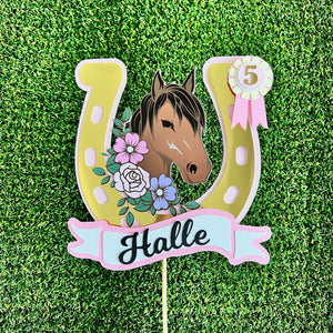 pony cake topper with a horse name and age on a ribbon