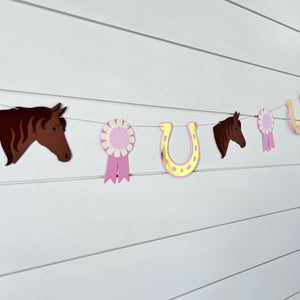 pony garland with ponies, gold foil horseshoe and pink ribbons
