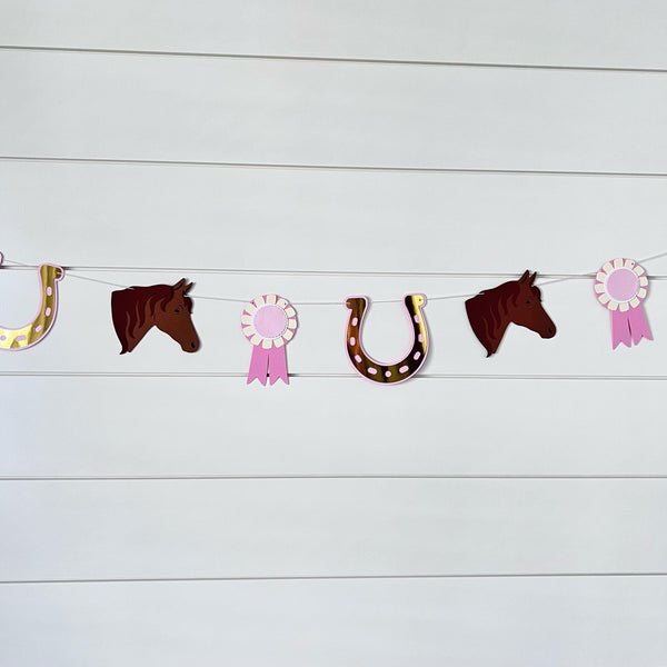 pony garland with ponies, gold foil horseshoe and pink ribbons