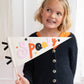 child holding the spooky felt pennant banner