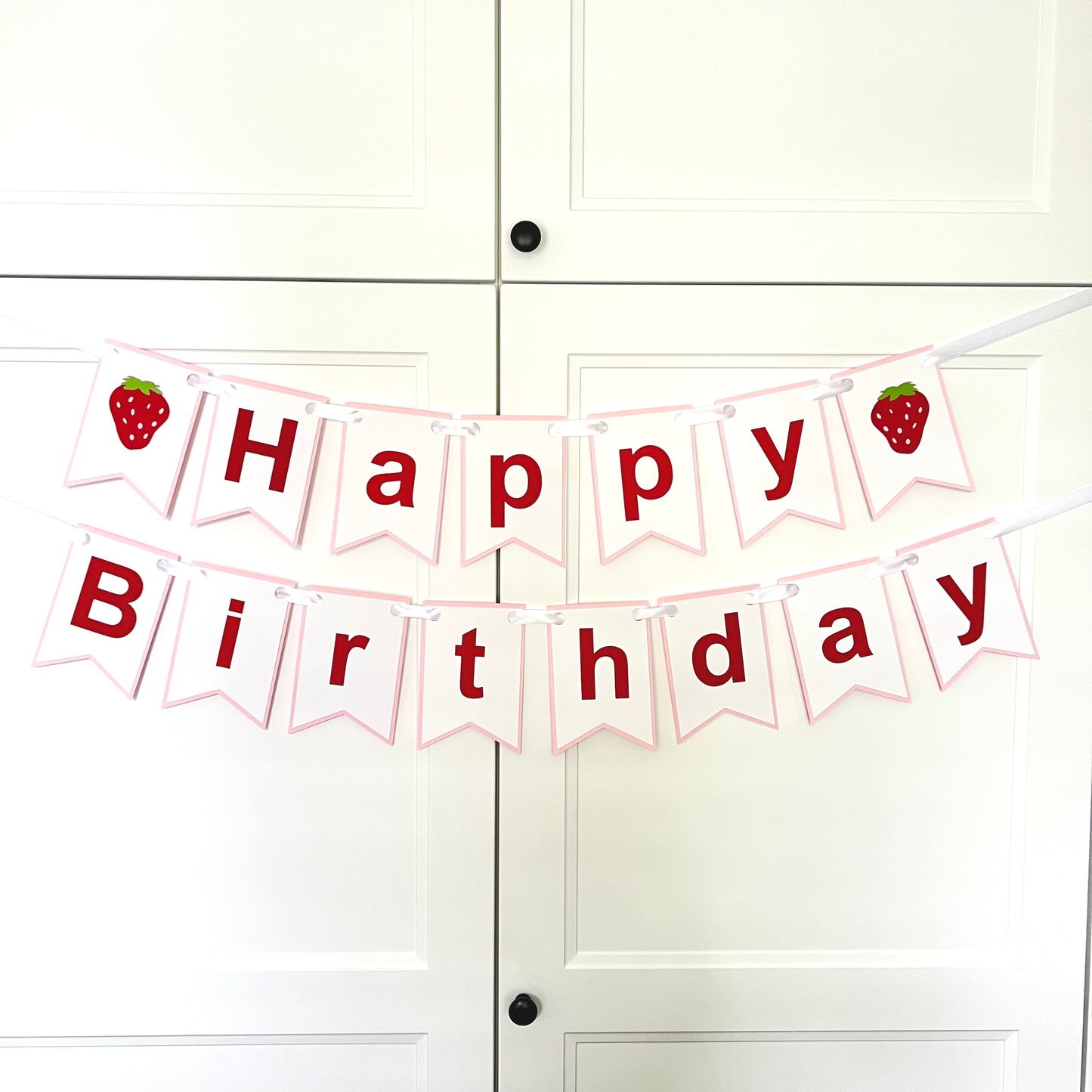 A 'Happy Birthday' banner with pink and white colors, featuring strawberry designs and the text 'HAPPY BIRTHDAY'.