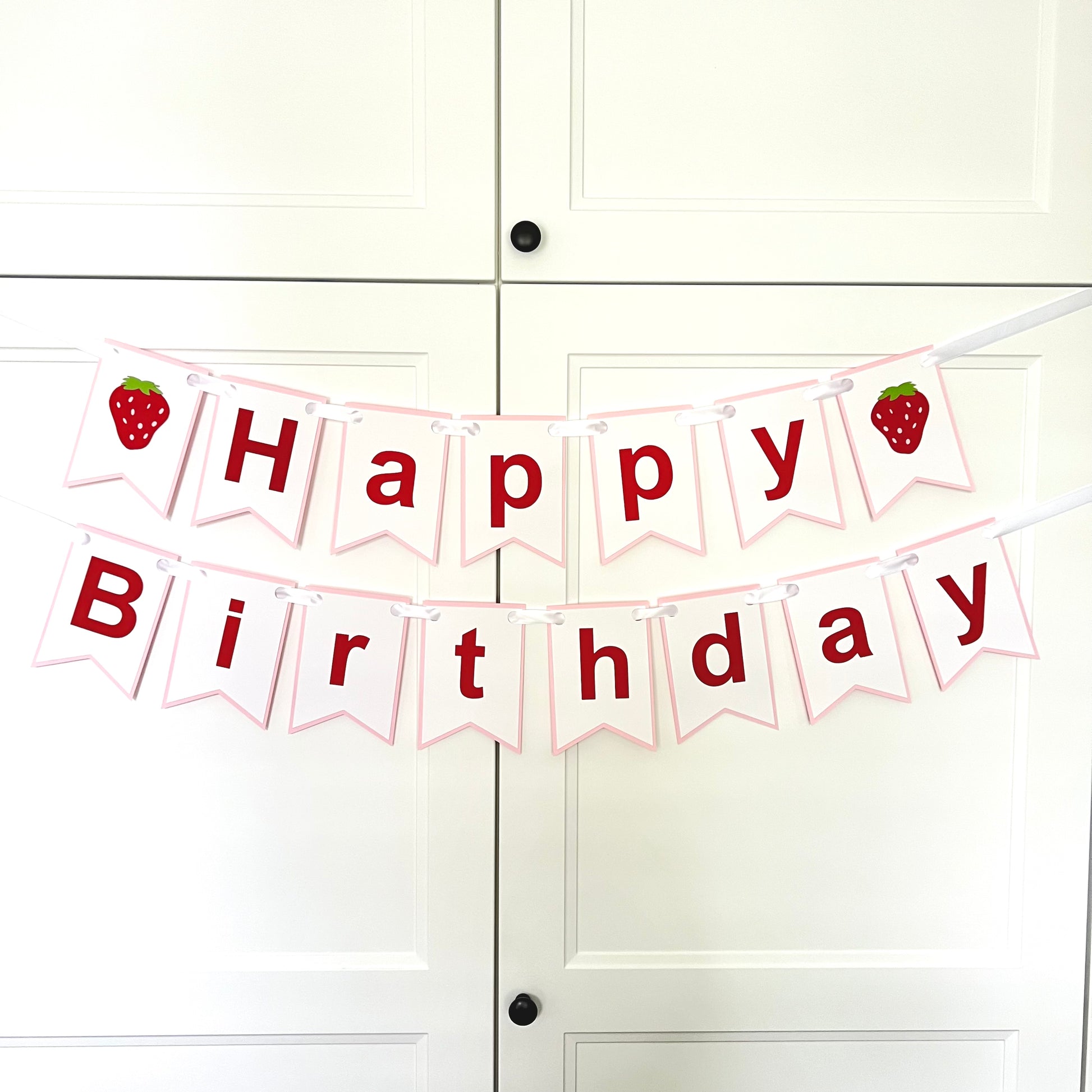 A 'Happy Birthday' banner with pink and white colors, featuring strawberry designs and the text 'HAPPY BIRTHDAY'.